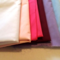 Assortment of coloured cotton material. Photo by Kath Howard (2013)